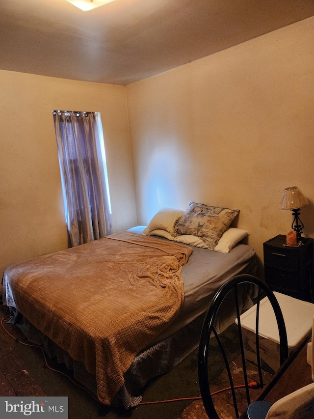 bedroom with dark hardwood / wood-style flooring