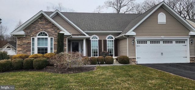 view of front of property with a front yard and a garage