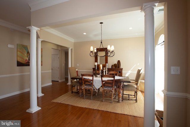 dining space with decorative columns, a notable chandelier, and dark hardwood / wood-style flooring