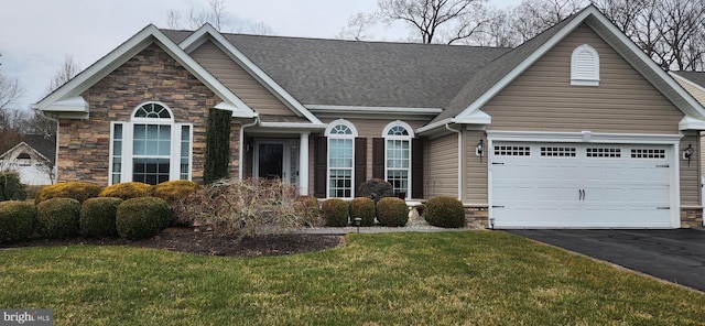 view of front of property with a front yard and a garage