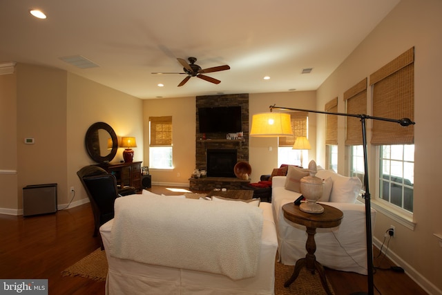 living room with a fireplace, ceiling fan, and hardwood / wood-style flooring