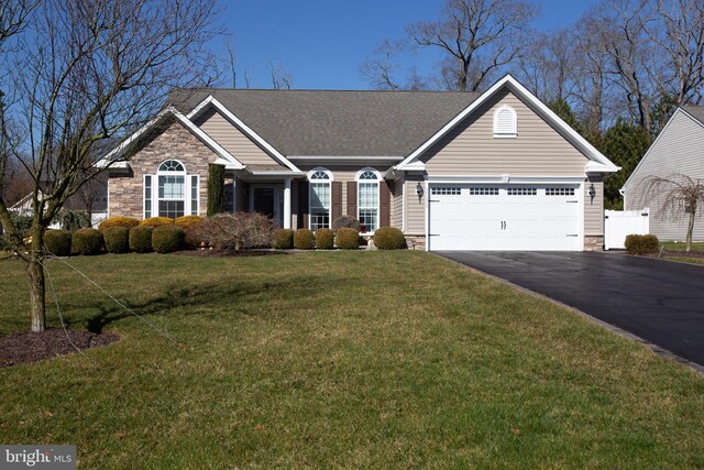 view of front of house featuring a front yard and a garage