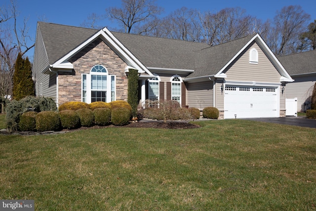 view of front of house featuring a front lawn and a garage