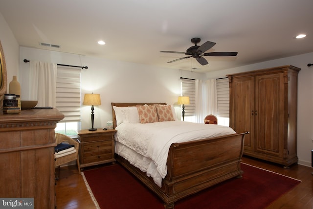 bedroom with ceiling fan and dark hardwood / wood-style floors