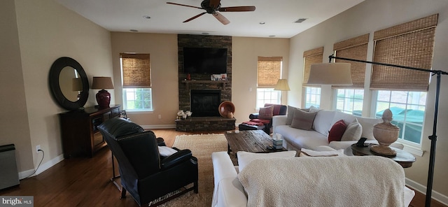 living room featuring dark hardwood / wood-style floors, ceiling fan, and a fireplace