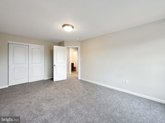 unfurnished bedroom with carpet and a closet