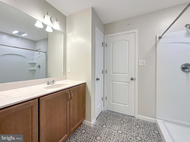 bathroom featuring vanity, tile patterned floors, and walk in shower