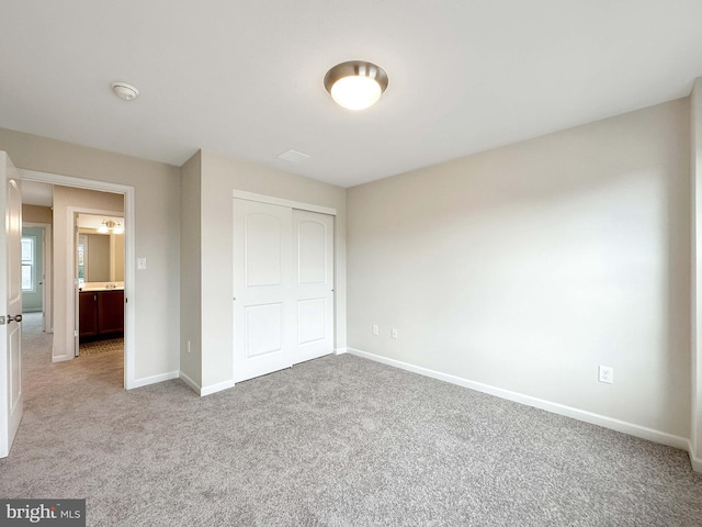 unfurnished bedroom featuring a closet and carpet