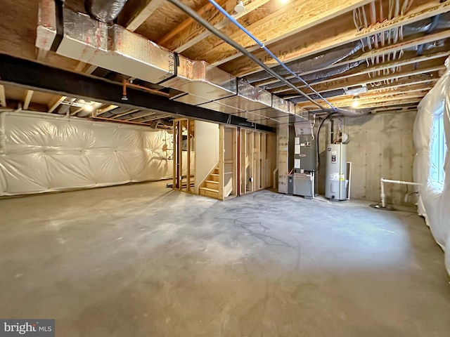 basement featuring water heater and heating unit