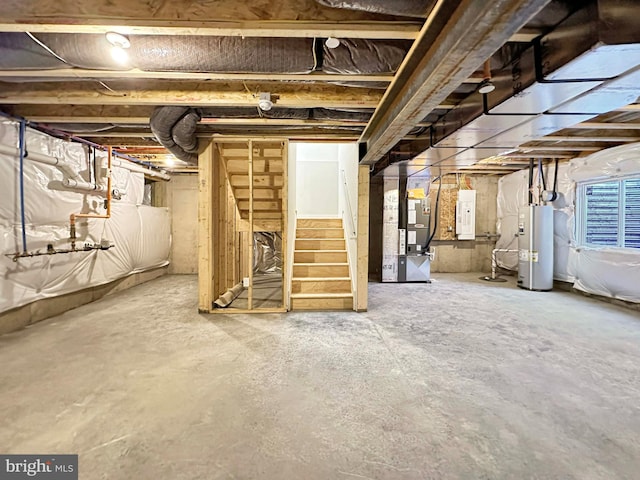 basement with water heater, electric panel, and heating unit