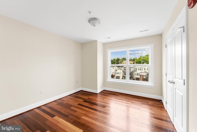 spare room with dark hardwood / wood-style floors