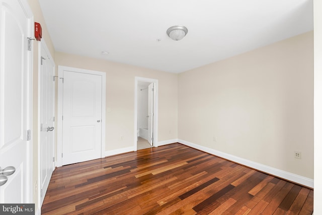 unfurnished bedroom with dark hardwood / wood-style floors