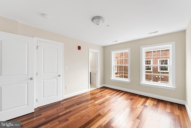 unfurnished bedroom featuring dark hardwood / wood-style flooring