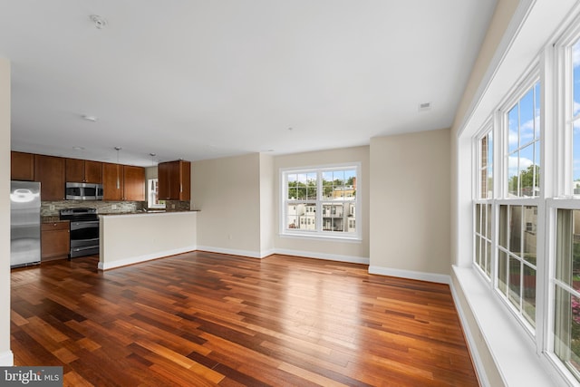 unfurnished living room with dark hardwood / wood-style flooring