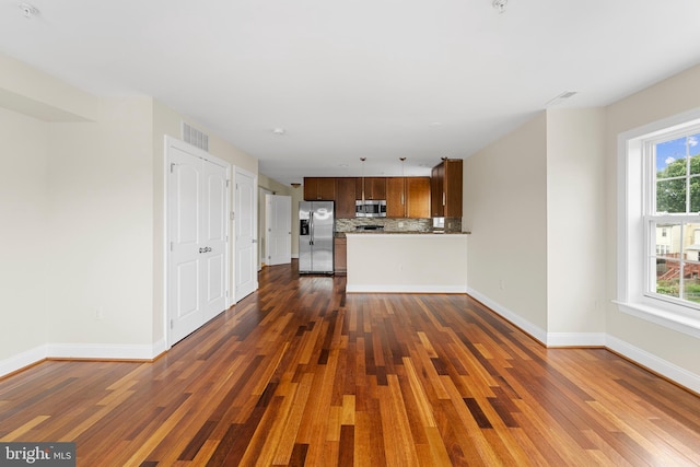 unfurnished living room with dark wood-type flooring