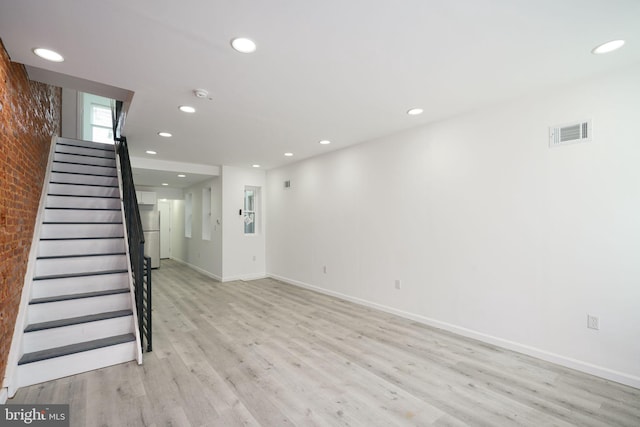 unfurnished living room with light wood-type flooring