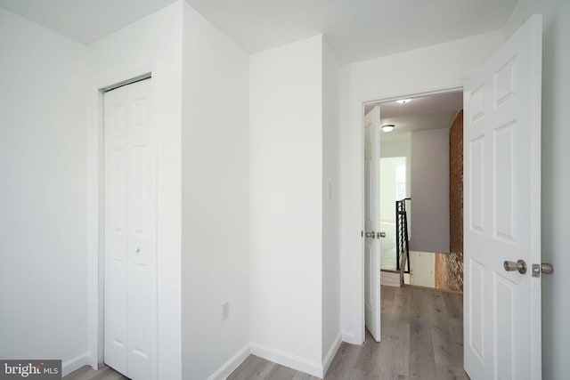 hall with light hardwood / wood-style flooring