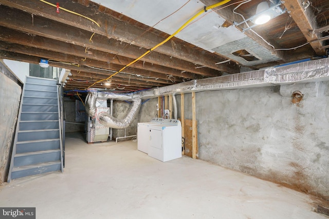 basement featuring washer and dryer and heating utilities