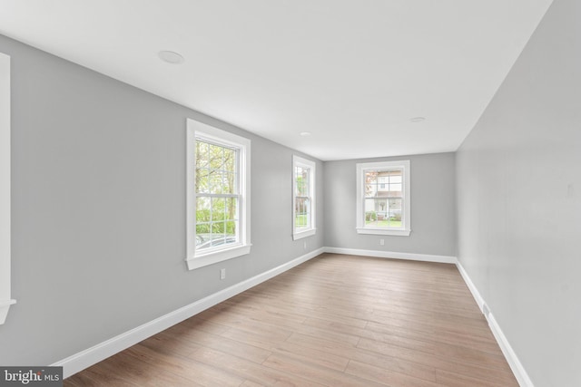 spare room with light hardwood / wood-style flooring