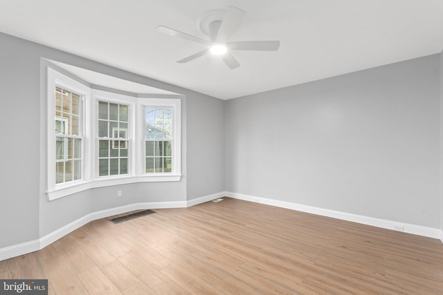 unfurnished room with ceiling fan and light wood-type flooring