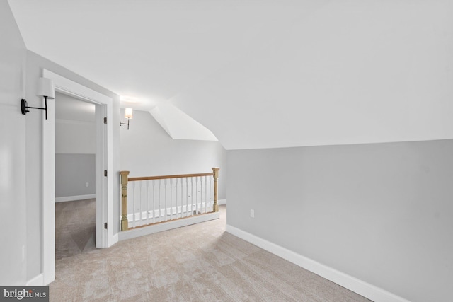 bonus room featuring light colored carpet and lofted ceiling