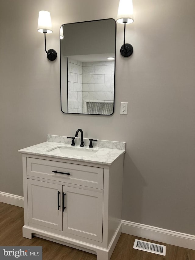 bathroom with hardwood / wood-style flooring and vanity