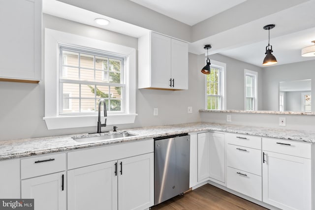 kitchen with dishwasher, sink, dark hardwood / wood-style floors, pendant lighting, and white cabinets