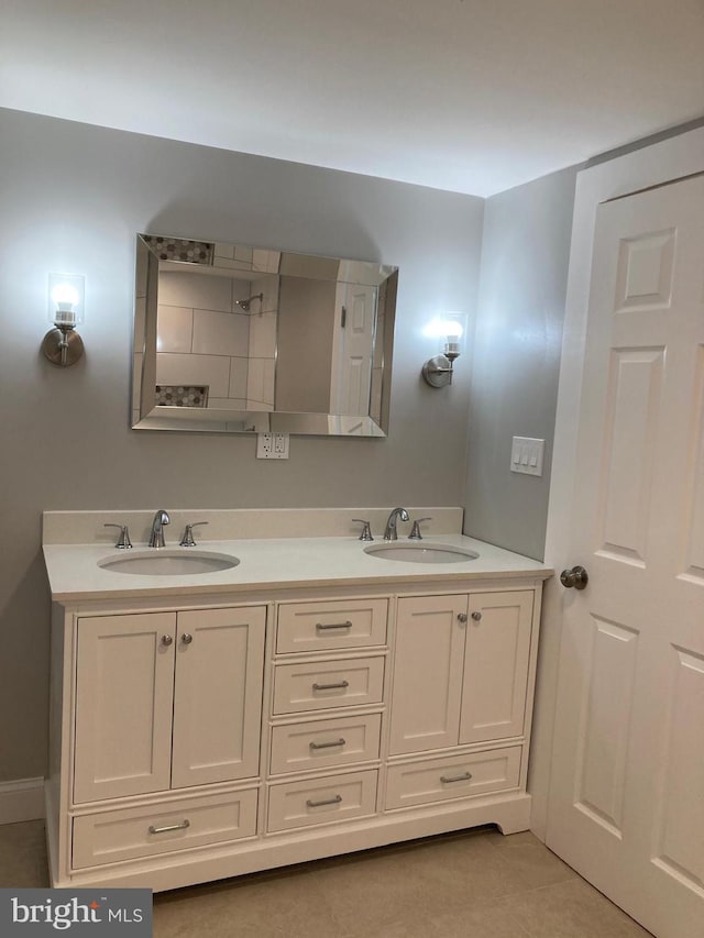 bathroom with tile patterned flooring and vanity