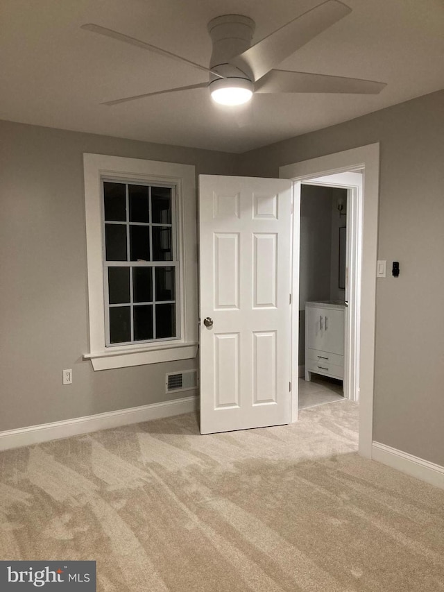 unfurnished bedroom with ceiling fan and light carpet