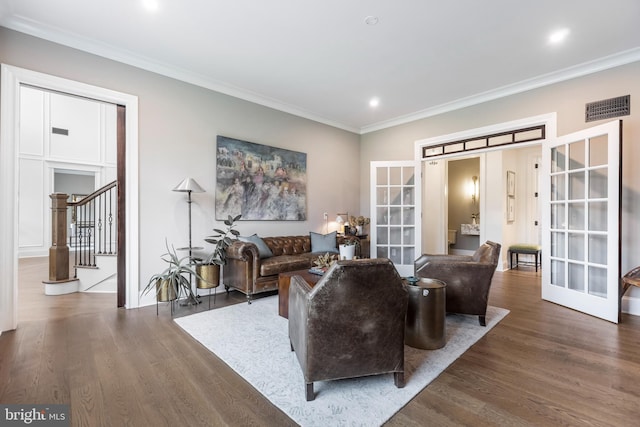 living room featuring ornamental molding, dark wood-type flooring, and french doors