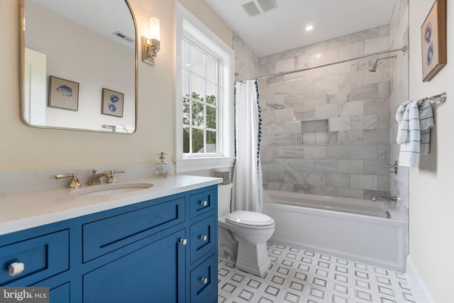 full bathroom featuring toilet, tile floors, vanity, and shower / bath combo with shower curtain