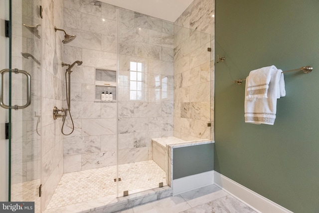 bathroom featuring tile flooring and a shower with shower door