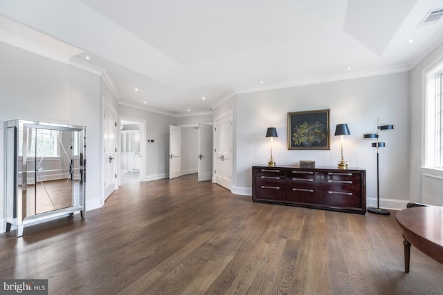 living room featuring dark hardwood / wood-style floors, ornamental molding, and a wealth of natural light