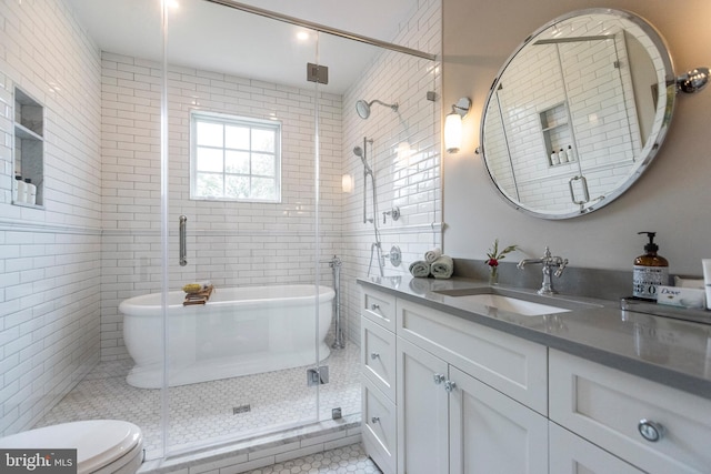 bathroom with tile flooring, toilet, an enclosed shower, and vanity with extensive cabinet space