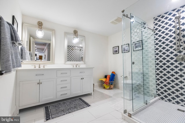 bathroom with tile flooring, dual vanity, and a shower with shower door