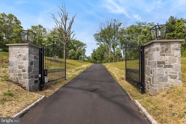 view of gate featuring a yard