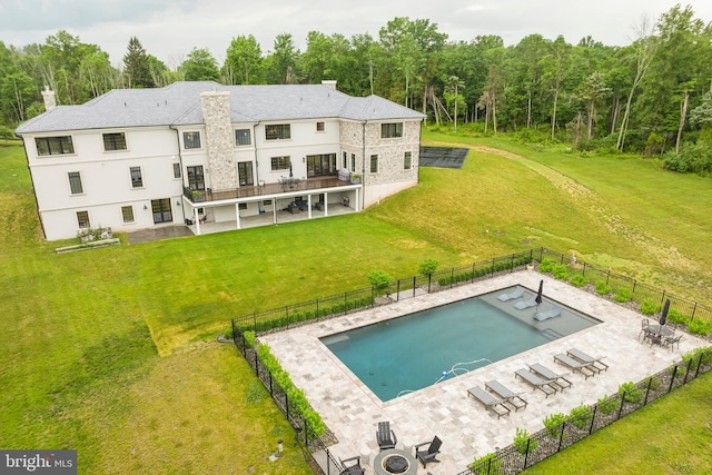 view of pool with a patio area and a lawn