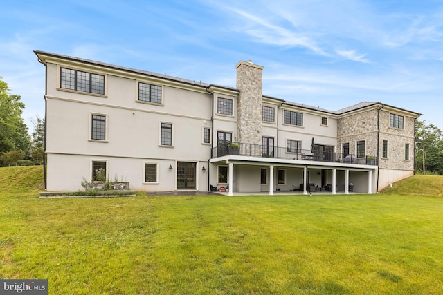 rear view of property featuring a yard