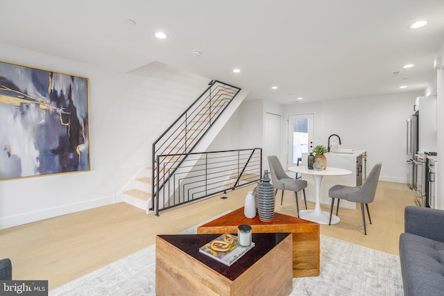 living room featuring light hardwood / wood-style flooring and sink