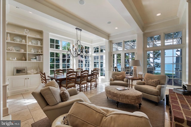 sunroom with french doors and a chandelier