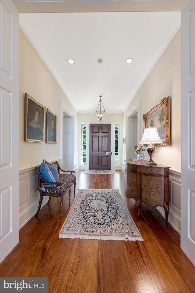 foyer featuring dark hardwood / wood-style flooring and ornamental molding