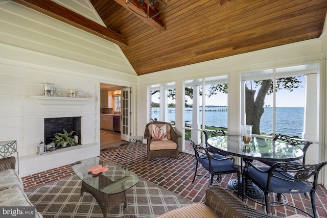 sunroom with a water view, lofted ceiling, sink, and wooden ceiling