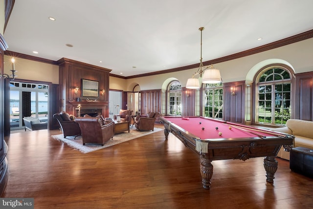 game room with hardwood / wood-style floors, crown molding, a fireplace, and pool table