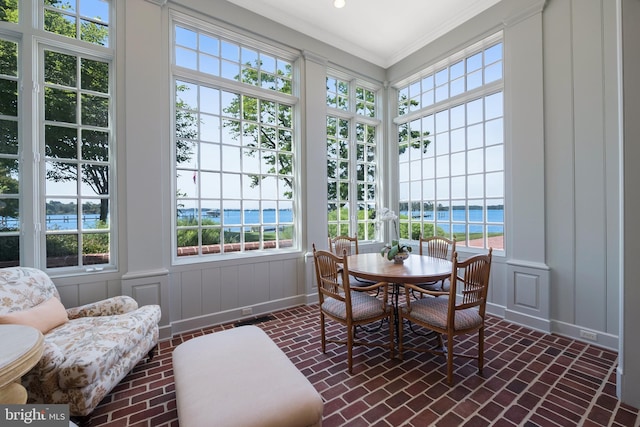 sunroom / solarium with a water view