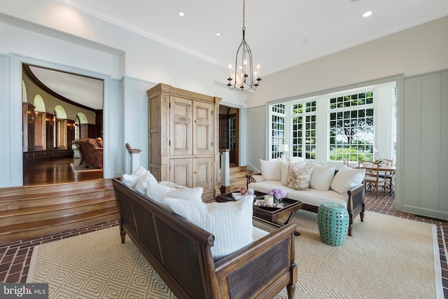 living room with ornamental molding and a notable chandelier