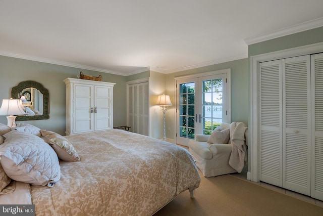 bedroom featuring access to exterior, french doors, carpet flooring, ornamental molding, and multiple closets