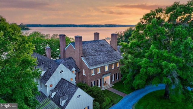 aerial view at dusk with a water view