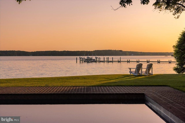 dock area featuring a water view and a lawn