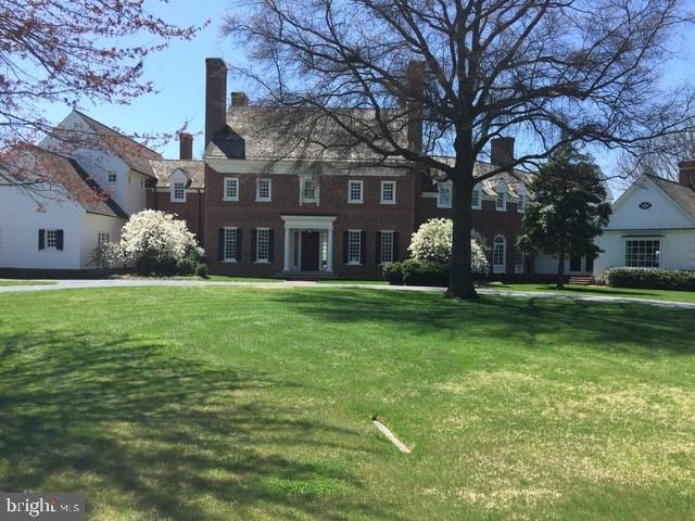 colonial home with a front yard