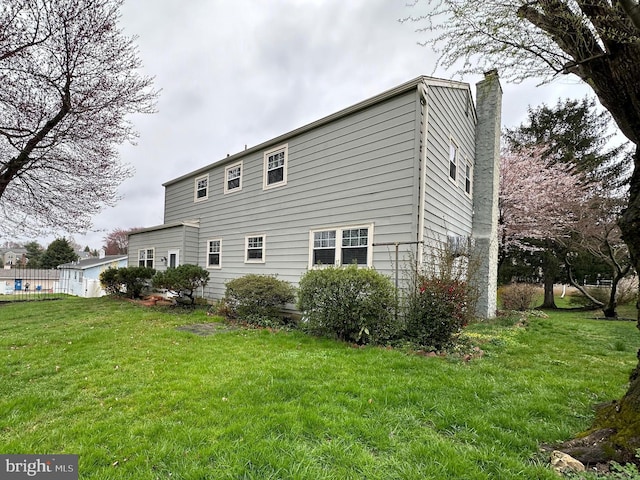 view of side of home featuring a yard